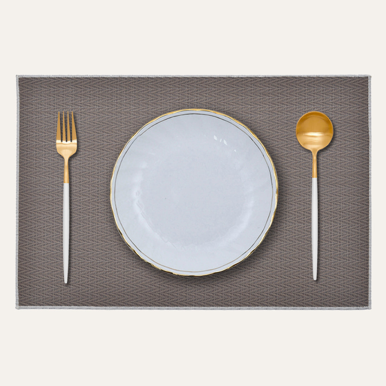 Dark gray PVC placemat with woven texture, rectangular with rounded corners