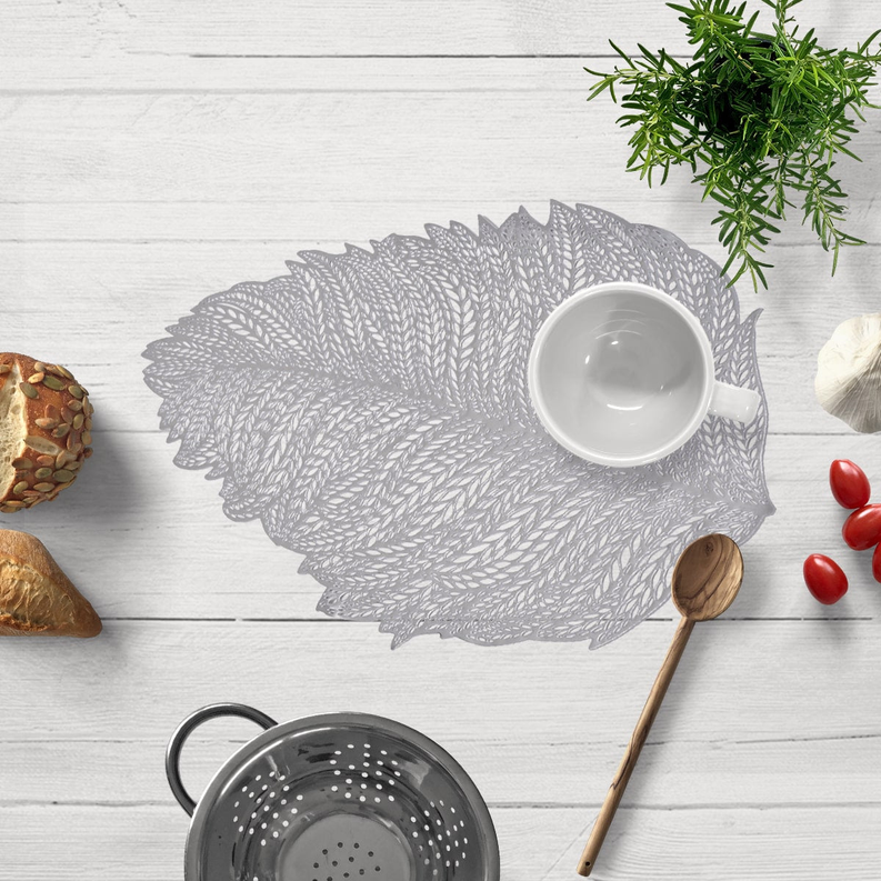Gray leaf cut-out vinyl placemat with intricate leaf-vein pattern, rounded oval shape