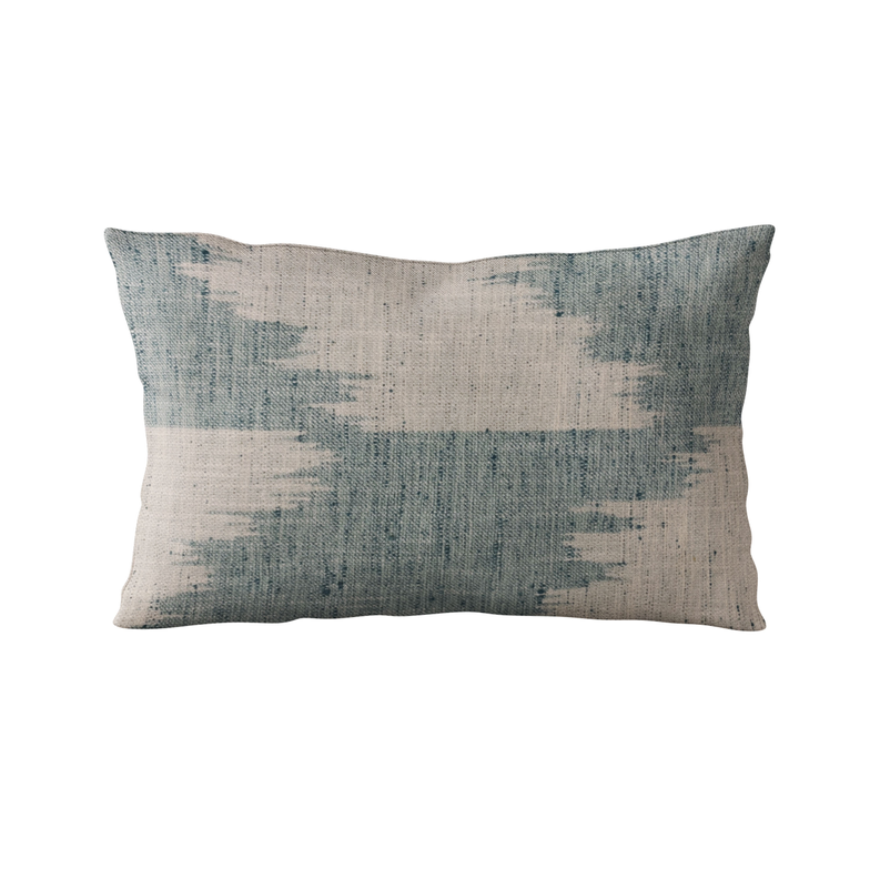 Blue and cream faded abstract throw pillow, textured fabric with horizontal bands.
