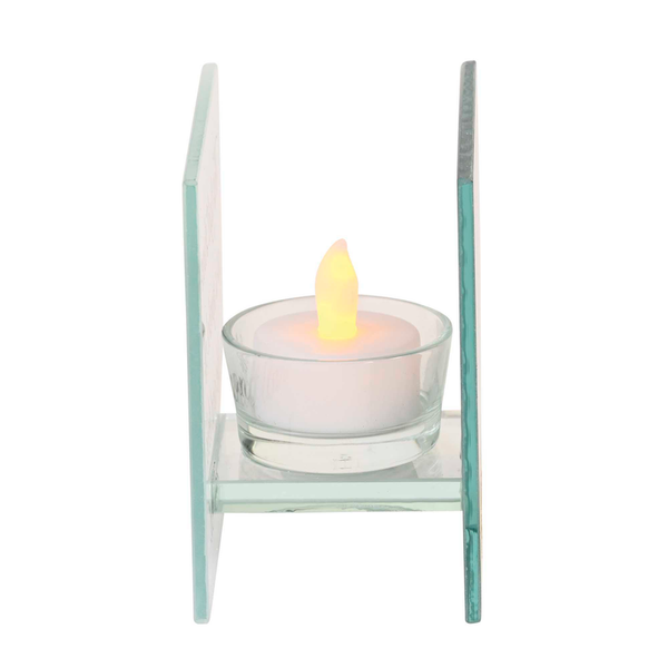 Glass tealight candle holder with lit flame in clear cup