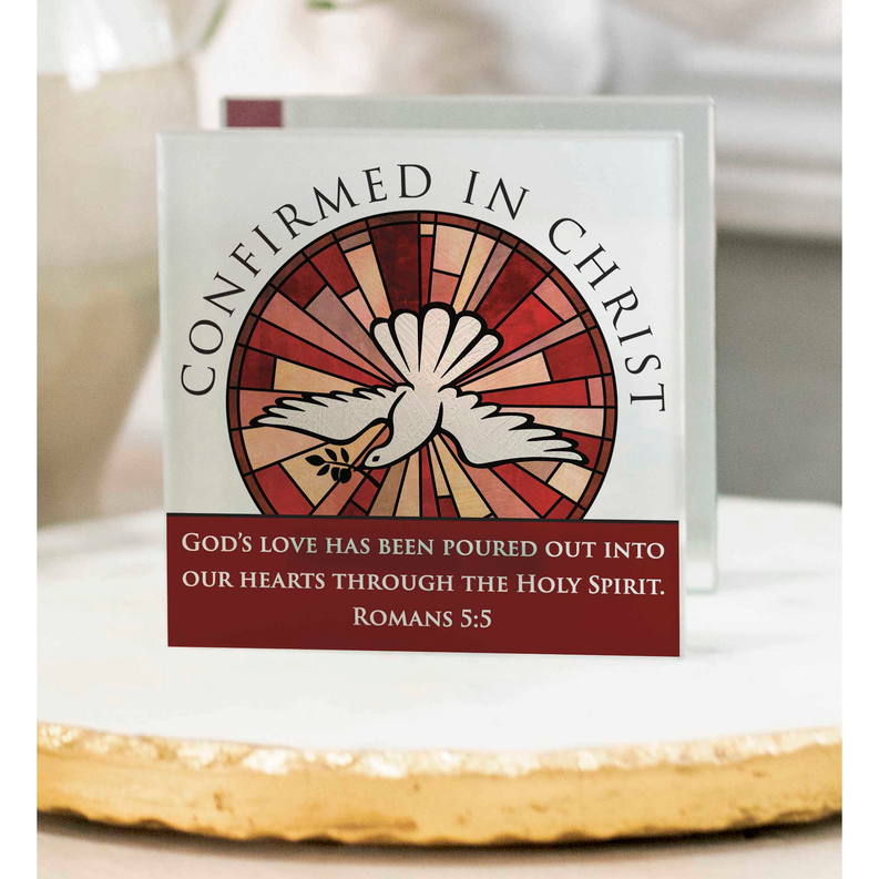 Tealight gift box front with red dove sunburst logo and Romans 5:5 quote
