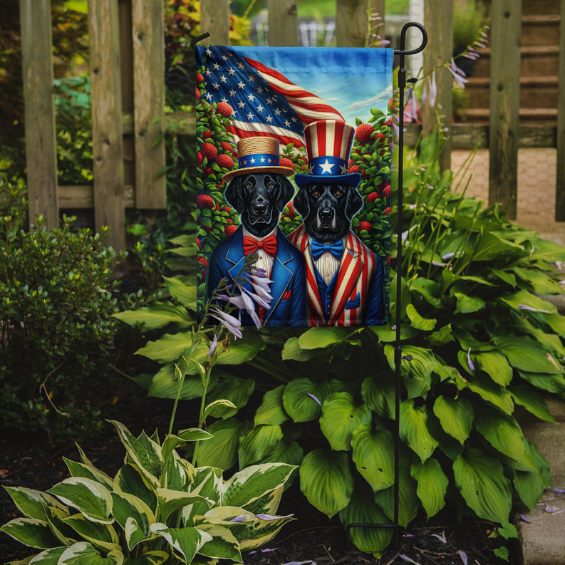 Patriotic garden flag featuring two black retrievers in blue patriotic outfits on a stake