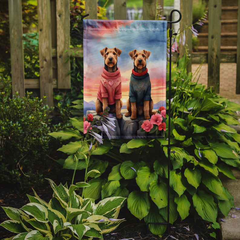 Two Airedale Terriers garden flag with pink and blue outfits in a heart-themed scene