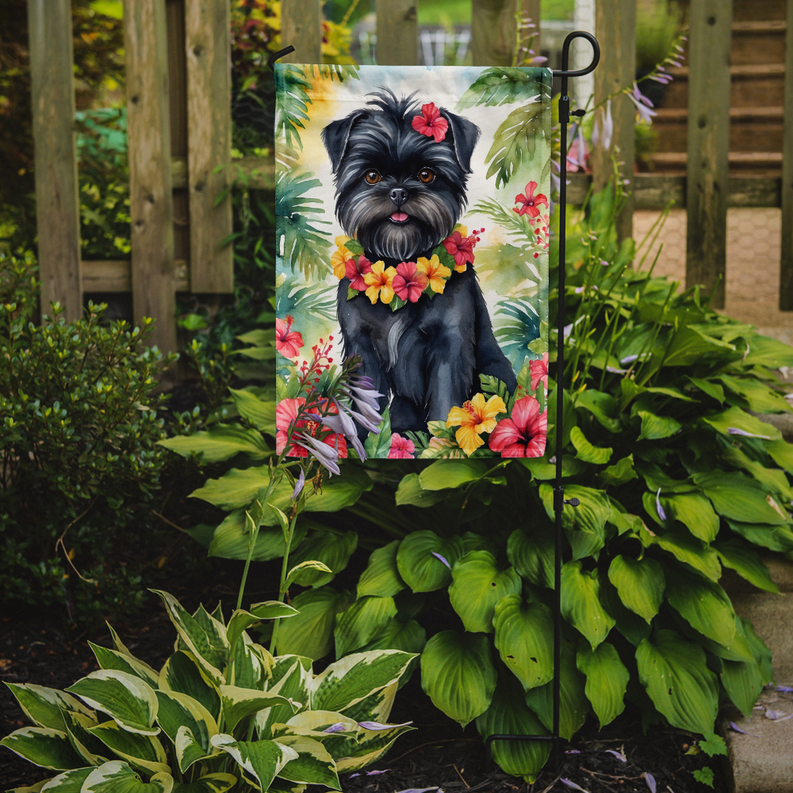 Garden flag on metal stand in garden, black dog with colorful flower collar