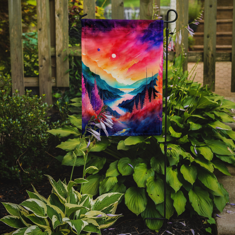 Galaxy landscape garden flag hanging on a metal stake among green plants