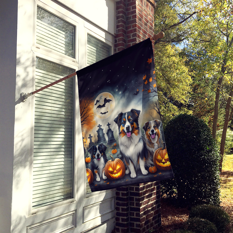Halloween house flag featuring three Australian shepherd dogs with pumpkins and tombstones