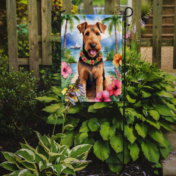 Luau garden flag with airedale terrier wearing floral lei beside tropical palms and flowers