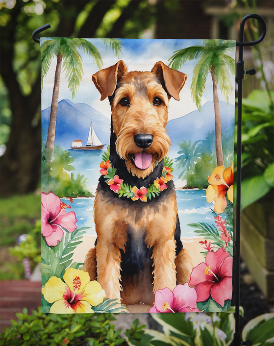 Luau garden flag on outdoor stake featuring airedale terrier with flower lei and tropical flowers
