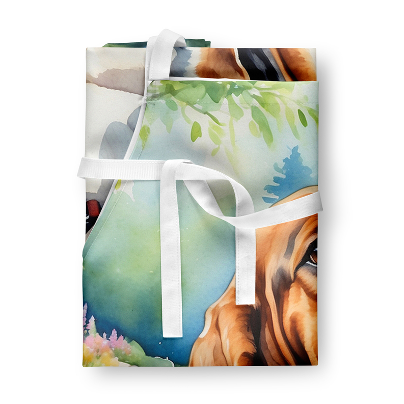 Stack of folded basset hound garden aprons with ribbon ties, layered prints