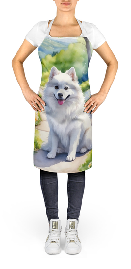 Garden apron on model with white dog portrait and blue-green watercolor scenery