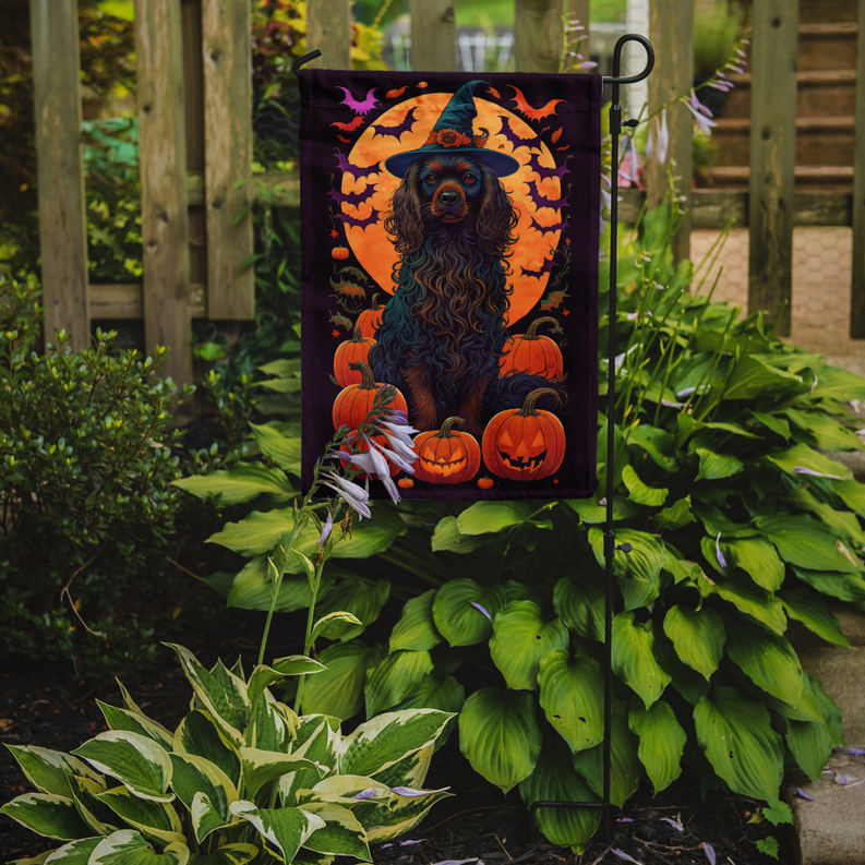 Halloween garden flag featuring dark spaniel in witch hat with pumpkins and bats