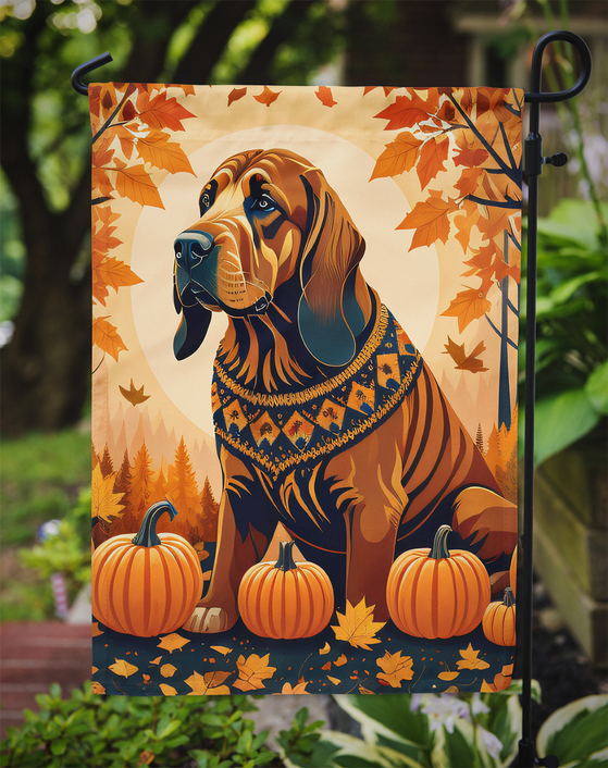 Fall garden flag with brown hound wearing bandana, orange leaves, and three pumpkins
