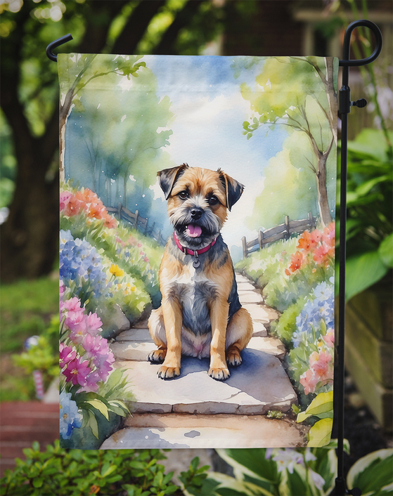 Garden flag close-up showing Border Terrier on spring garden path