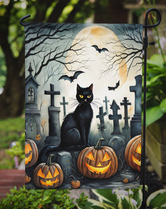 Spooky Halloween garden flag with black cat by tombstones and glowing jack-o'-lanterns