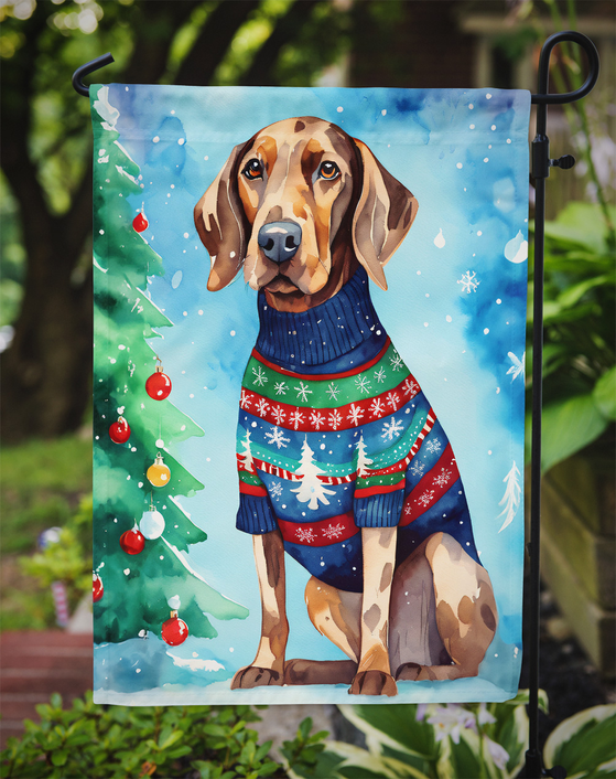 Christmas garden flag featuring a brown-and-white hound in blue festive sweater near a decorated tree