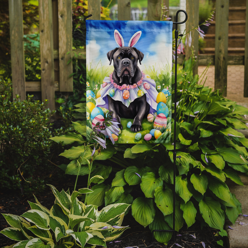 Easter garden flag on a pole with black puppy, pink garland, and Easter eggs