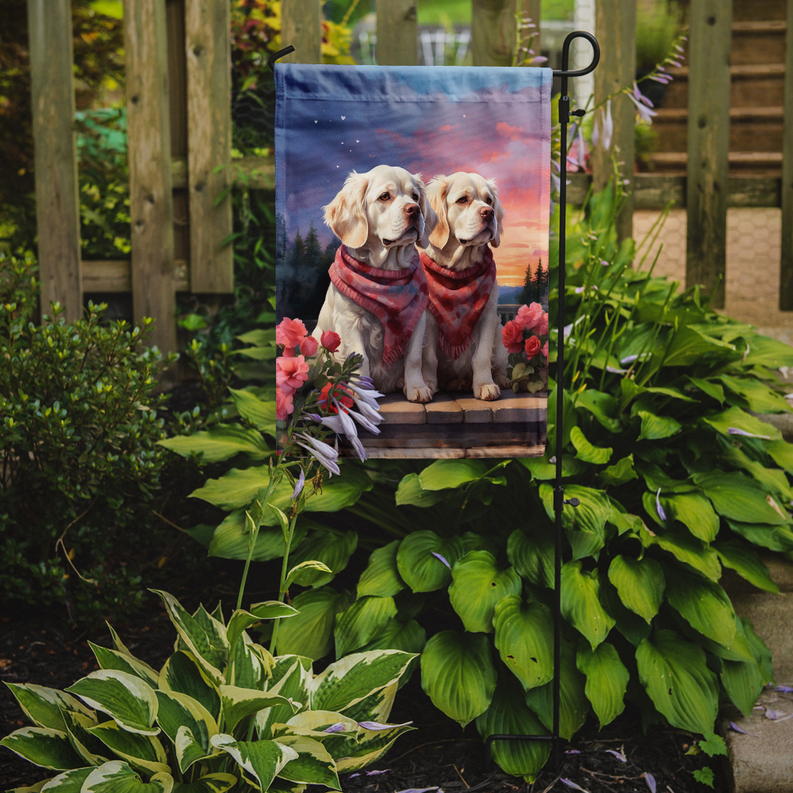 Clumber spaniel heart garden flag on stake beside flowers with two dogs in red bandanas