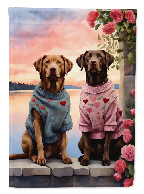Two Hearts garden flag close-up: two retrievers in blue and pink sweaters