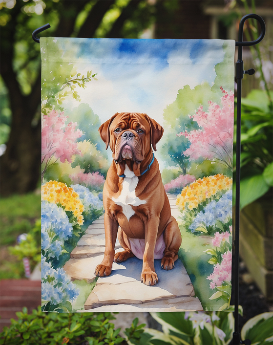 Close-up garden flag showing brown dog sitting on garden path