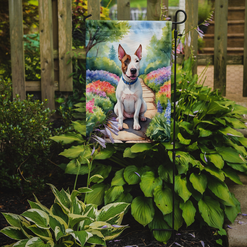 Garden flag hanging on a stand, featuring a dog on a flower-lined walkway