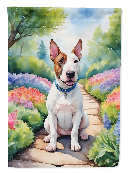Garden flag featuring a white-and-brown dog sitting on a flower-lined path