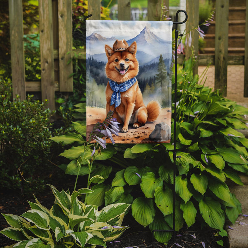 Garden flag on stake showing cowboy corgi and mountain scene