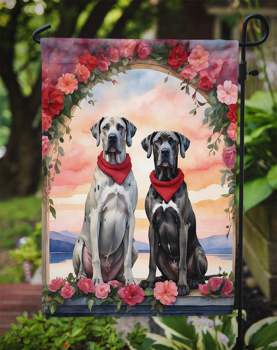 Garden flag with two Great Danes in red bandanas and floral arch, outdoors