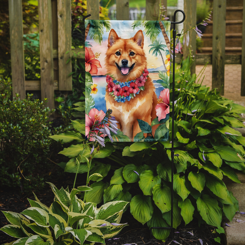 Garden flag displayed in garden with orange dog and flower lei