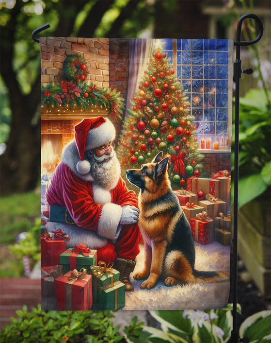 Hanging garden flag with Santa and German Shepherd beside a decorated Christmas tree