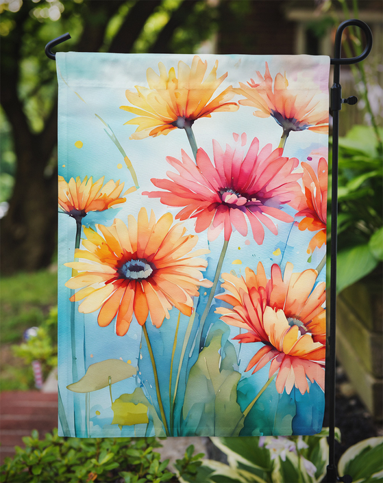 Watercolor gerbera daisy garden flag with orange, pink, and yellow flowers on blue background