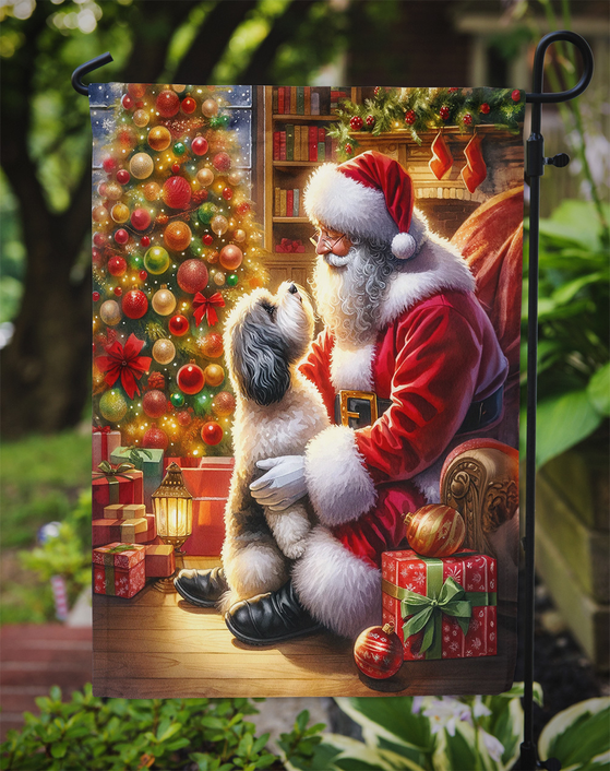 Holiday garden flag on a stake with Santa holding a Havanese dog amid gifts