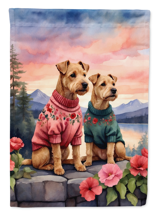Garden flag showing two Lakeland terriers in sweaters on a pastel mountain scene