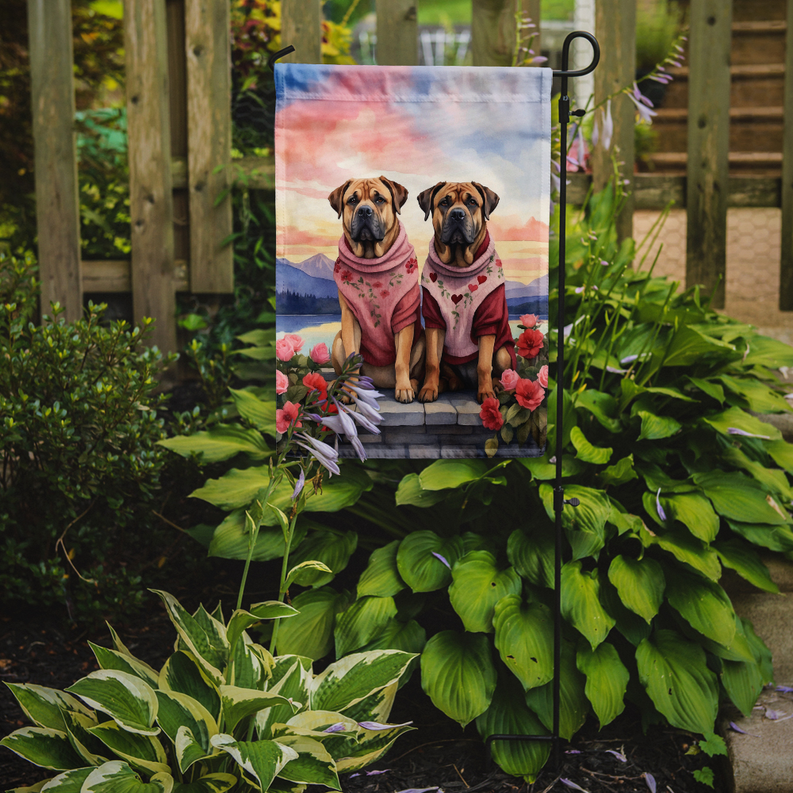 Garden flag with two mastiff dogs in pink scarves, sitting on a stone ledge