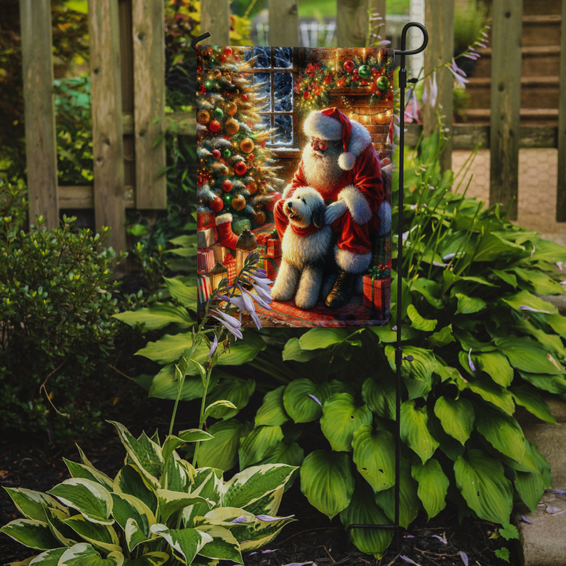 Garden flag hanging on a stake in a garden, Santa and old english sheepdog scene