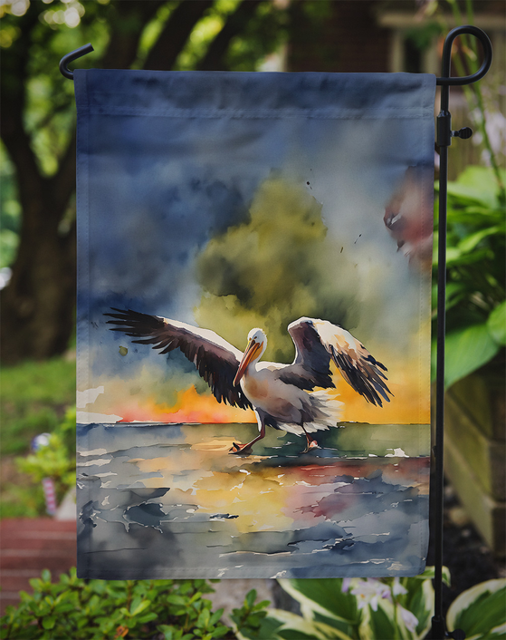 Pelican garden flag hanging on a pole with blue watercolor art and top pocket.