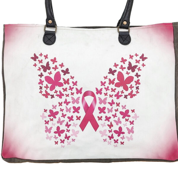 Market tote with pink ribbon and butterfly graphic, black webbed handles and trim
