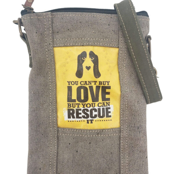 Small crossbody bag in earthtone canvas with front Rescue Love-style patch and strap.