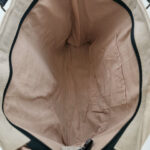 Recycled military tent shoulder bag interior with beige lining and black trim