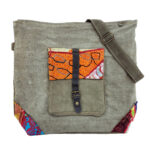 Earthtone vintage crossbody bag with front patch panel, side strap, and buckles
