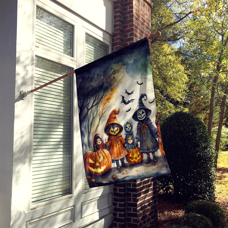 Halloween house flag hanging outside with kids, pumpkins, and witchy artwork