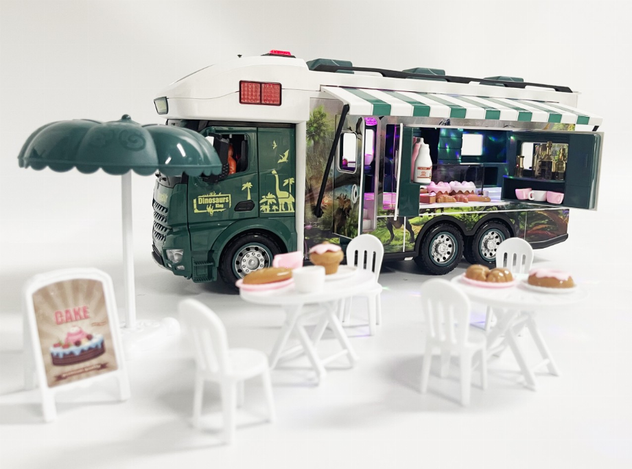 Jurassic toy RV with awning and interior play area, dinosaur figures and mini tables