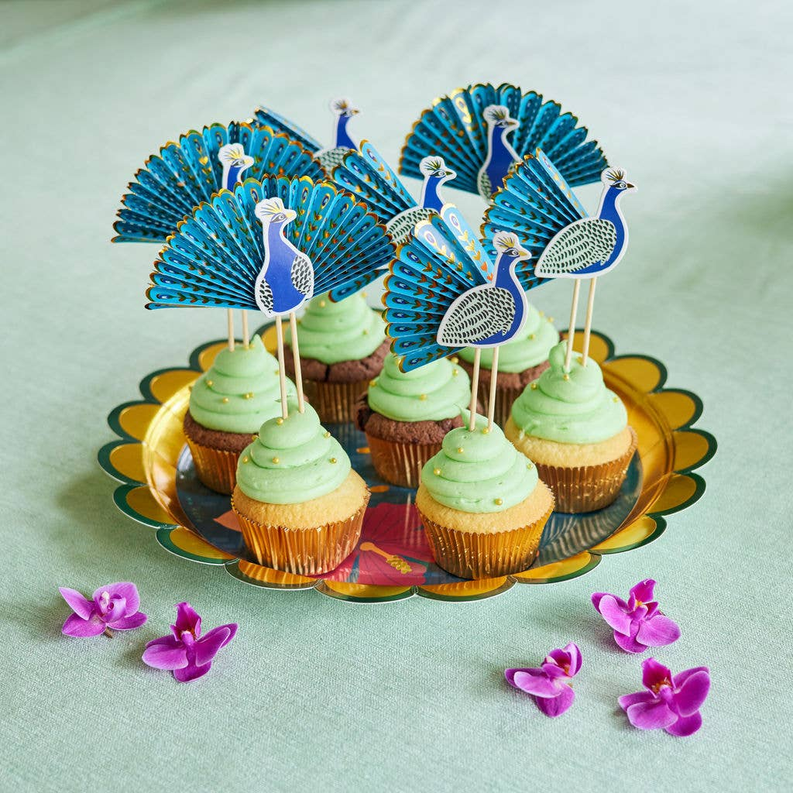 Cupcakes with blue bird toppers on mint green frosting, on a decorative tray