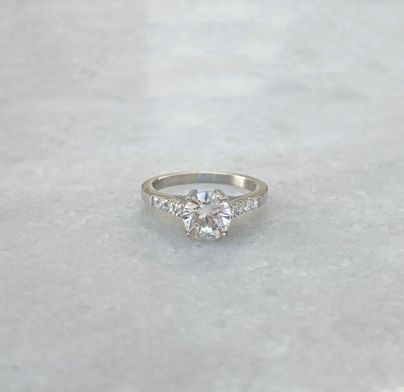 Silver promise ring with round center stone and pavé side stones