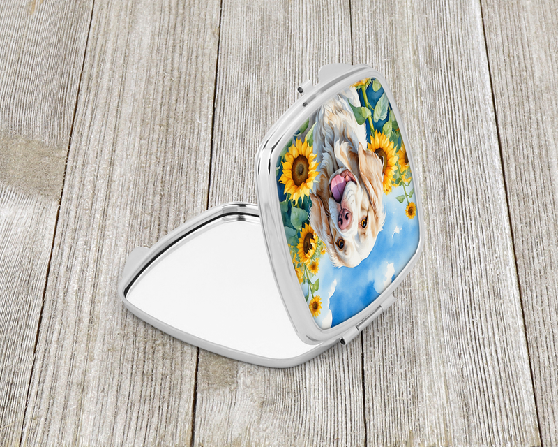 Silver compact mirror, open with sunflower dog portrait on the lid, side view