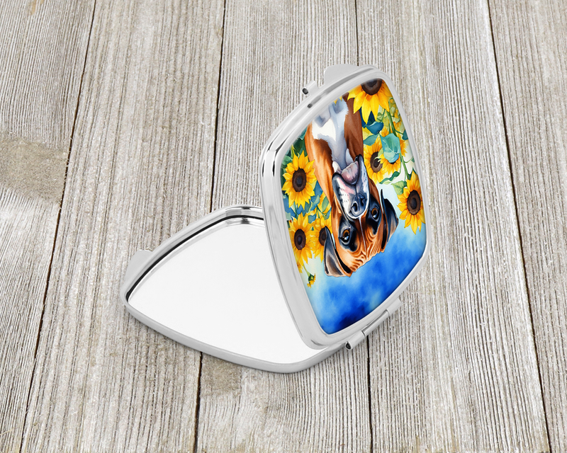 Open compact mirror, side view showing silver edge and white boxer sunflower artwork.