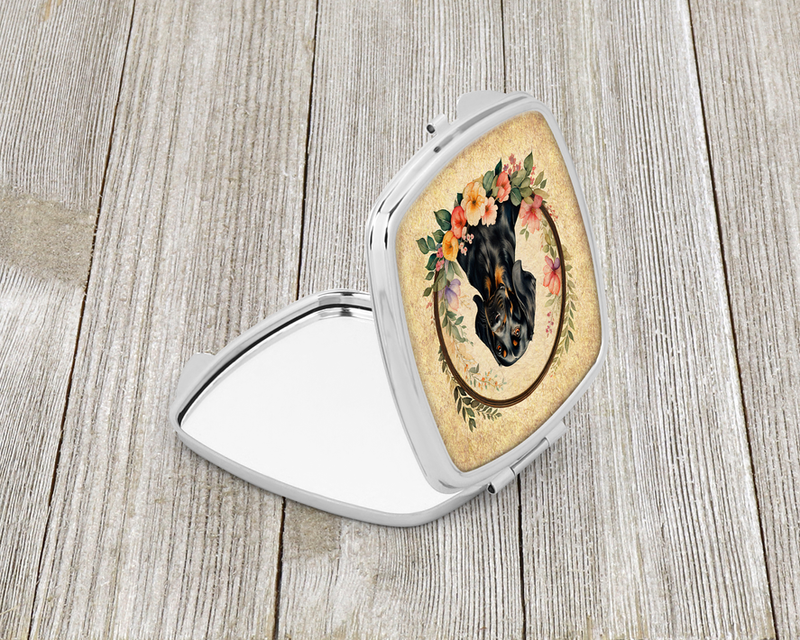 Silver compact mirror with hinged open cover and dark dog floral oval artwork