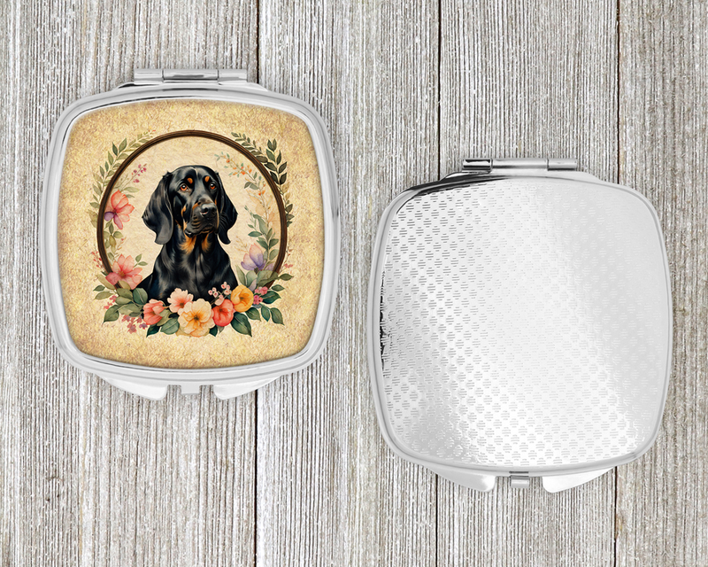 Silver compact mirror with hinged open cover and dark dog portrait with floral wreath