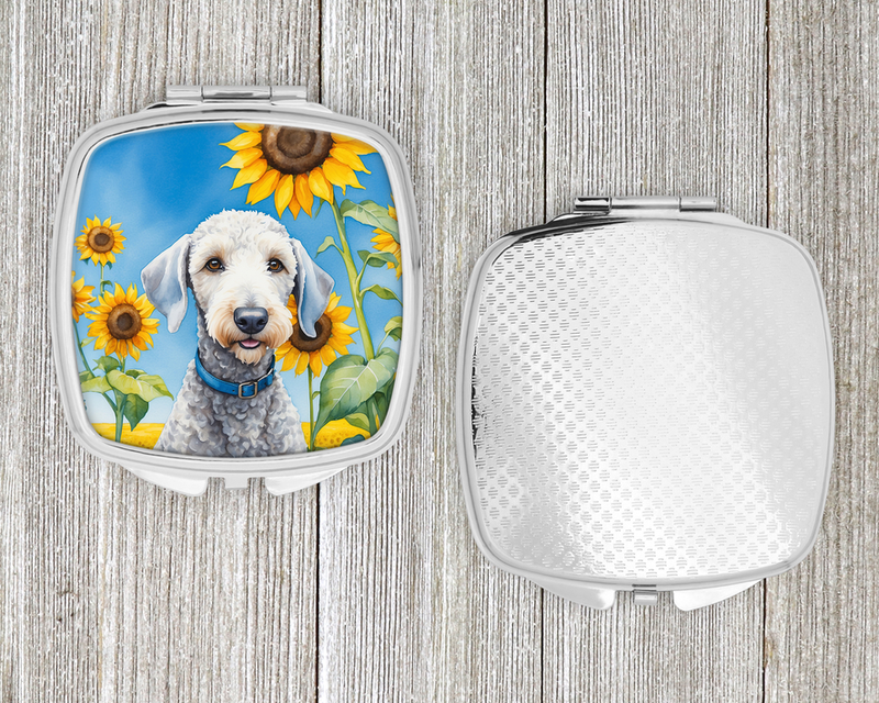 Compact mirror set: terrier sunflower lid on left, textured light-gray back on right.