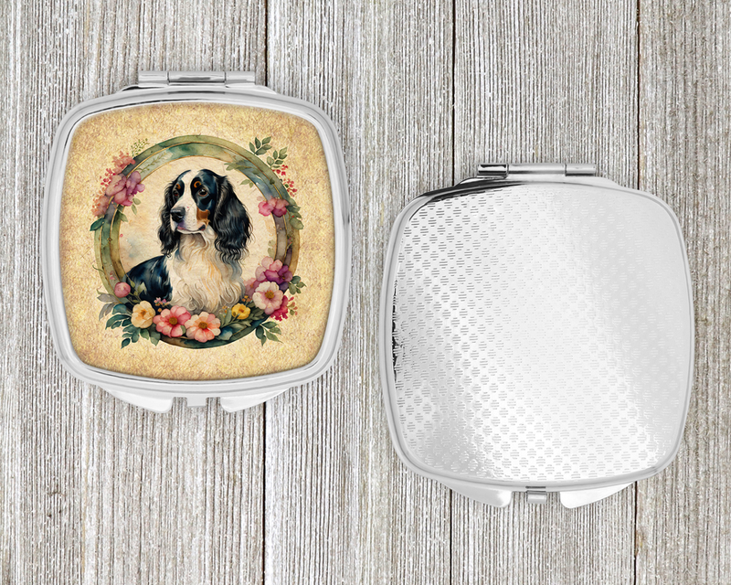 Silver compact mirror with decorative textured back cover, open hinge