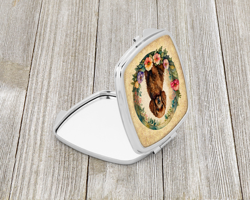 Silver compact mirror, open with oval dog-and-flowers insert